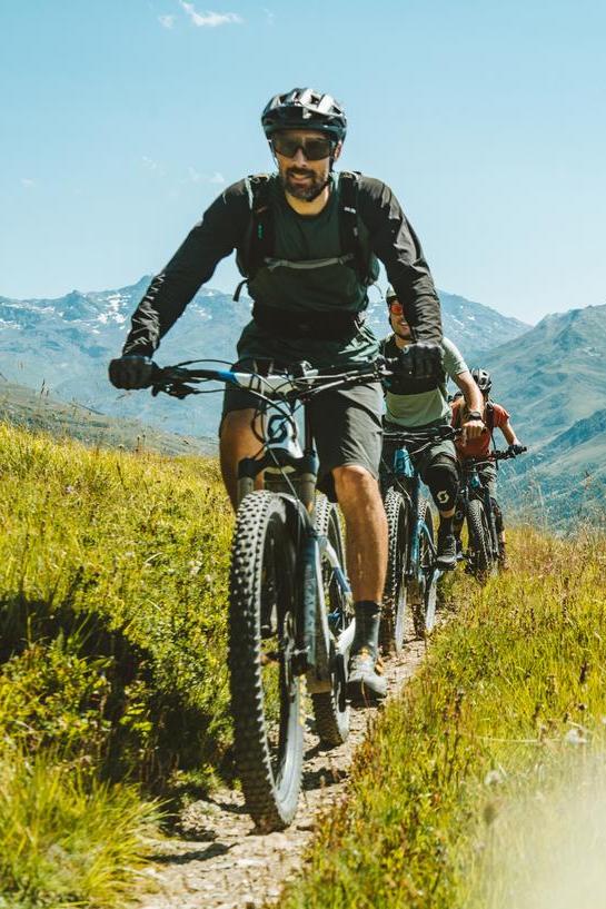 Group of mountain bikers on a 4x4 trail with panoramic views